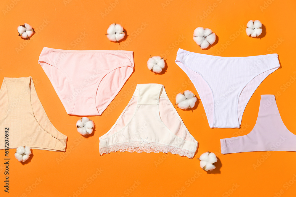 Composition with female panties and cotton flowers on color background