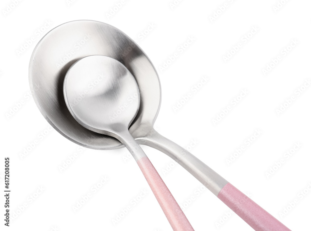 Stainless steel spoons with pink handles on white background