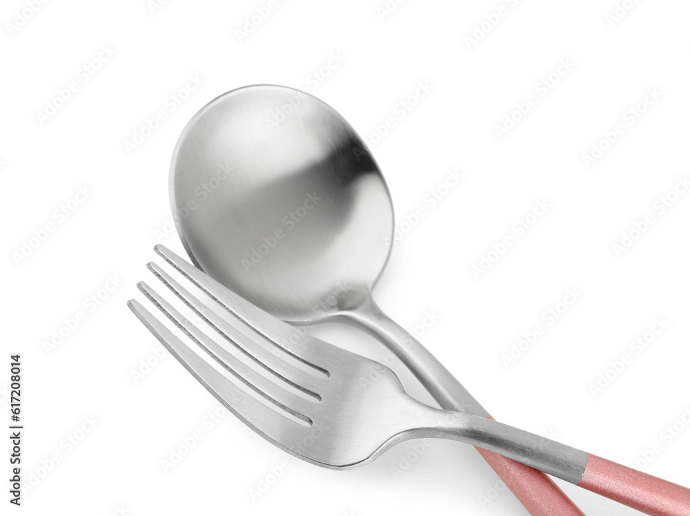 Stainless steel spoon and fork with pink handles on white background