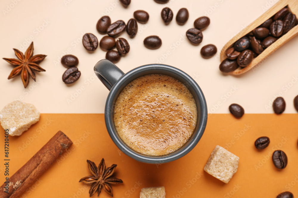 Cup of hot espresso, sugar, cinnamon and coffee beans on color background