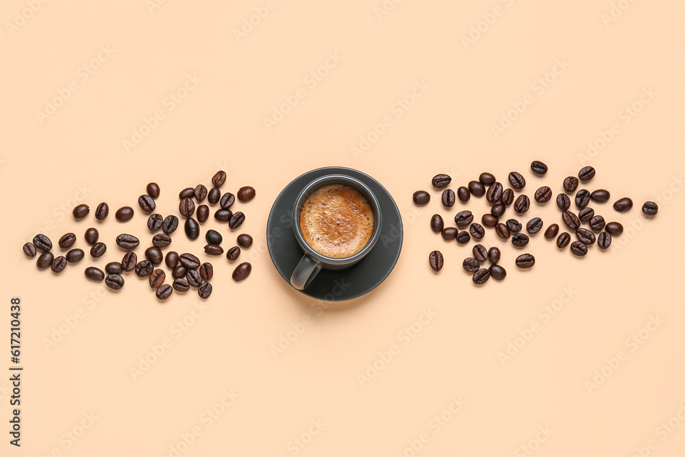 Cup of hot espresso and coffee beans on beige background