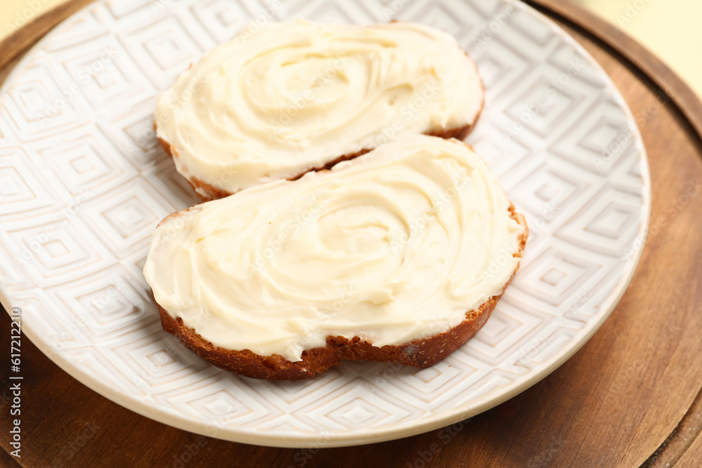 Plate of tasty sandwiches with cream cheese on table