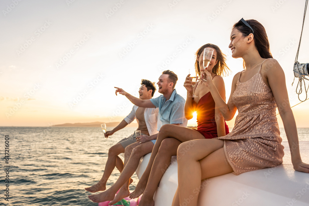 Group of diverse friends drink champagne while having a party in yacht