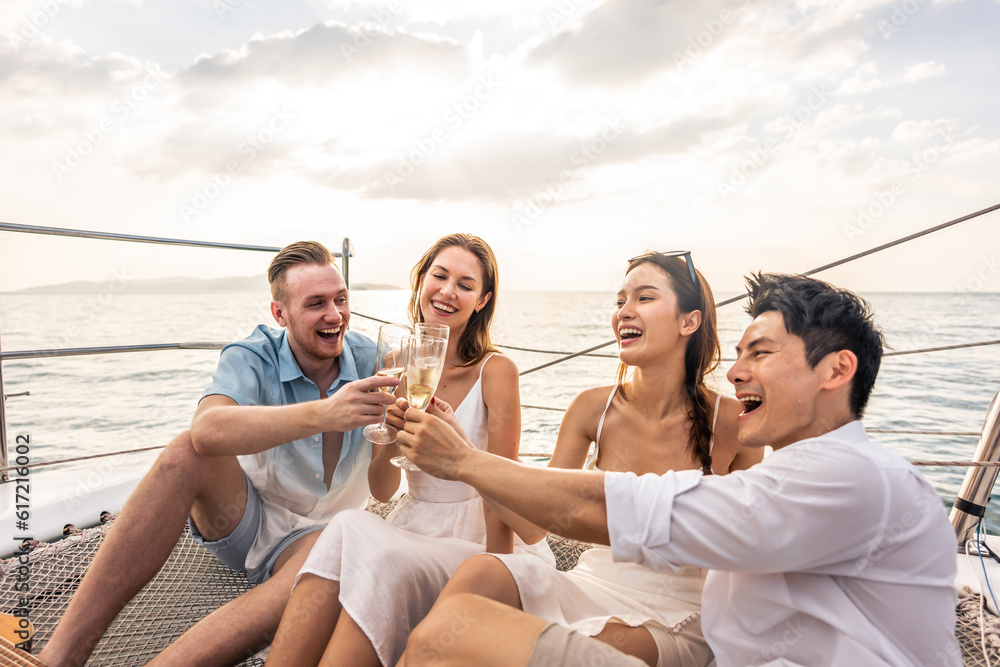 Group of diverse friends drink champagne while having a party in yacht. 