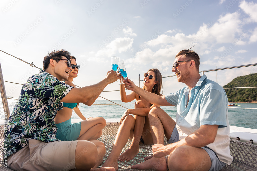 Group of diverse friends drink champagne while having a party in yacht. 