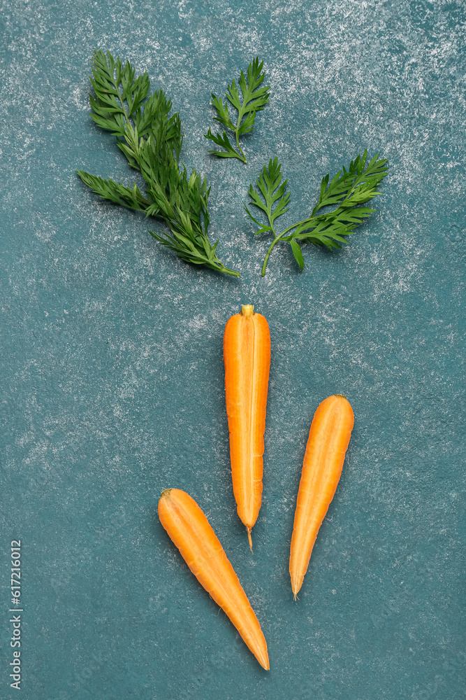 Slices of fresh carrots on green background