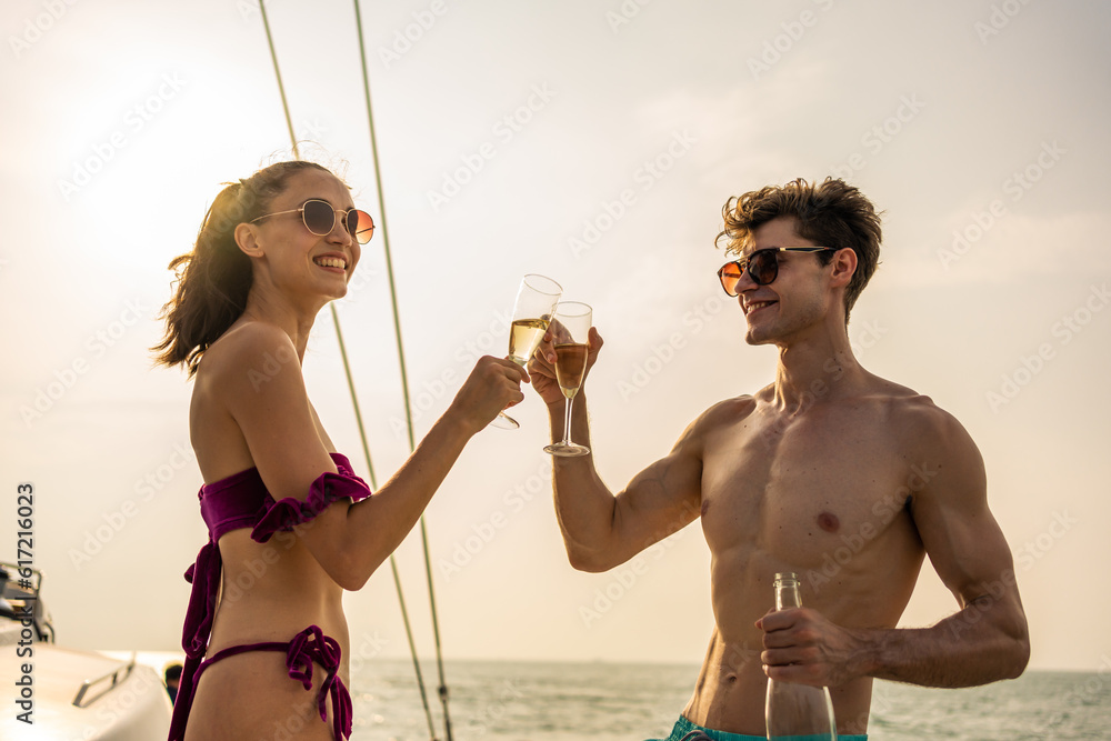 Caucasian young couple drinking champagne while having party in yacht. 