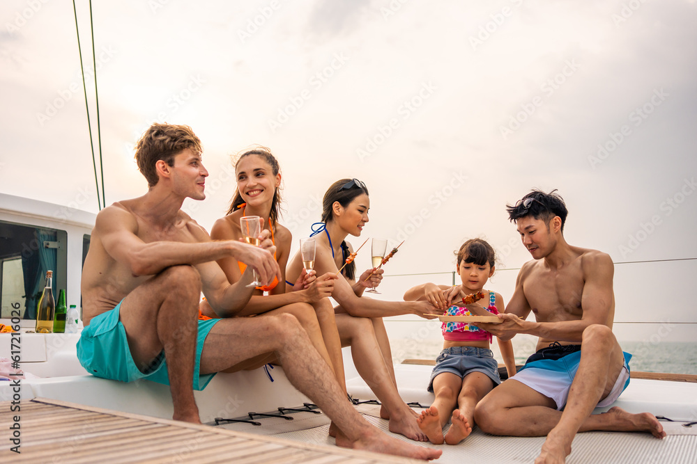 Group of diverse friends eating barbecue while having a party in yacht. 