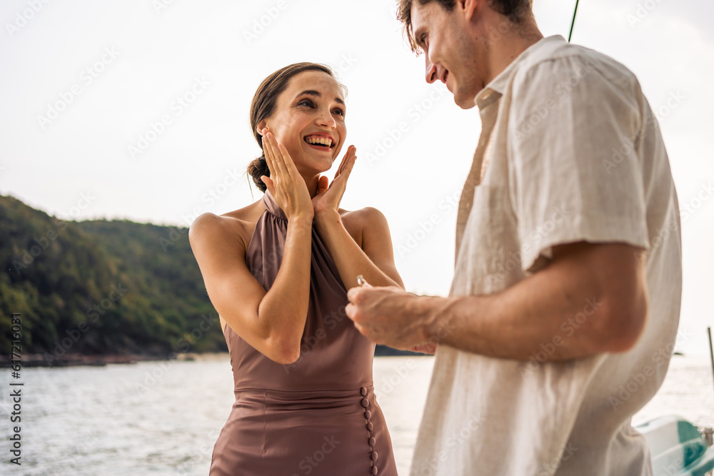 Caucasian young man make surprise proposal of marriage to girlfriend. 