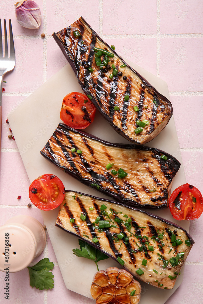 Delicious grilled eggplants, tomatoes and spices on light background