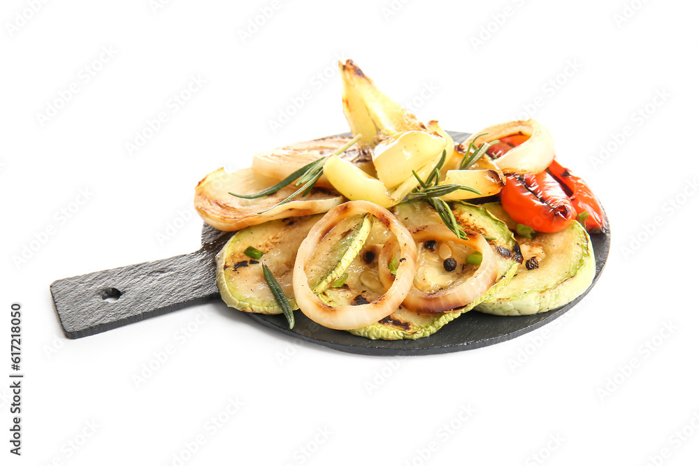 Slate board with different tasty grilled vegetables on white background