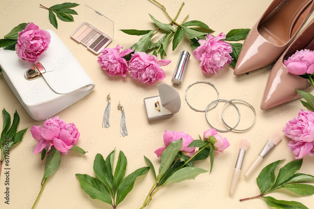 Composition with beautiful engagement ring, stylish accessories, cosmetics and peony flowers on colo