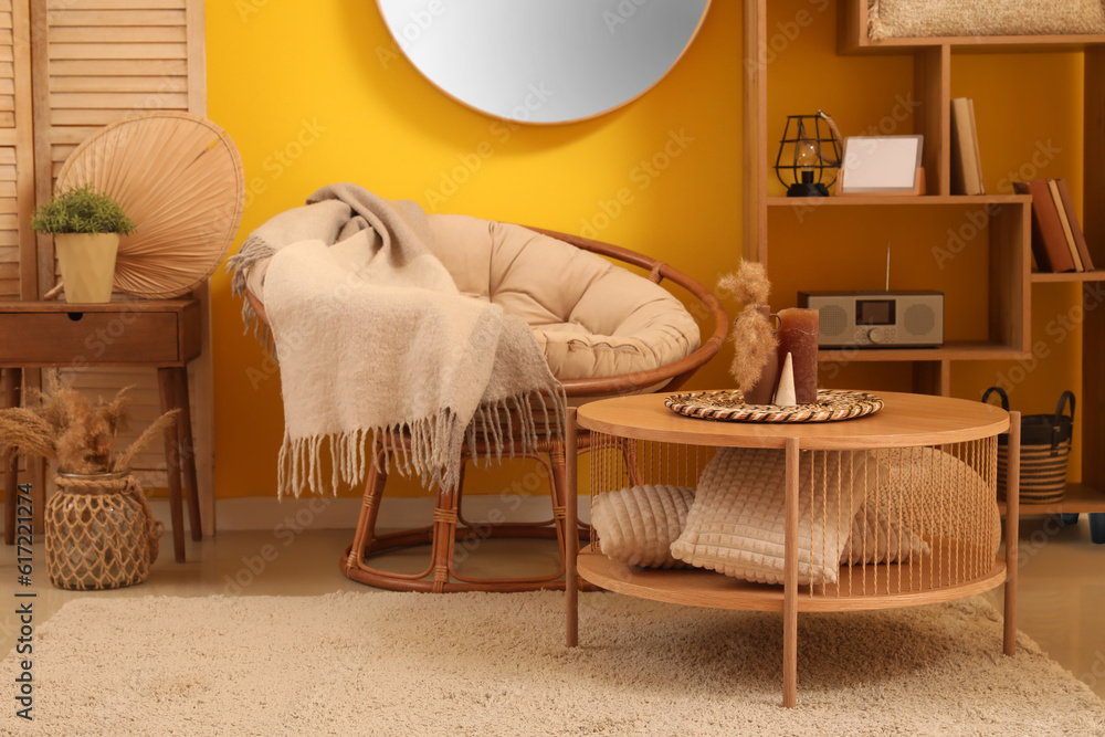 Interior of living room with armchair and wooden table