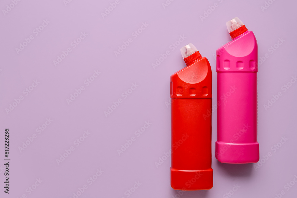 Bottles of detergent on lilac background