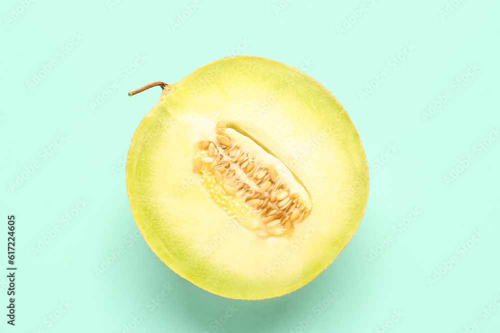 Half of sweet melon on turquoise background