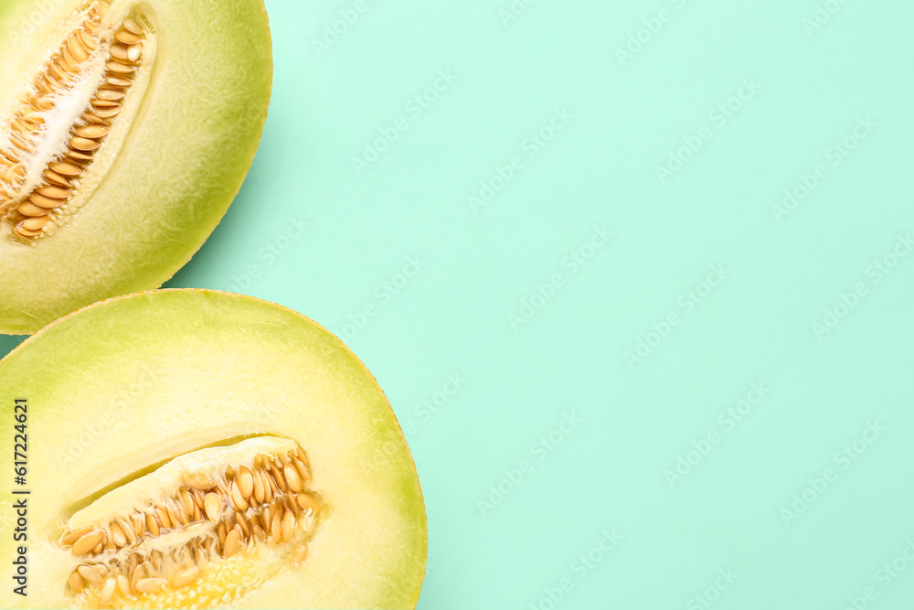 Half of sweet melon with piece on turquoise background