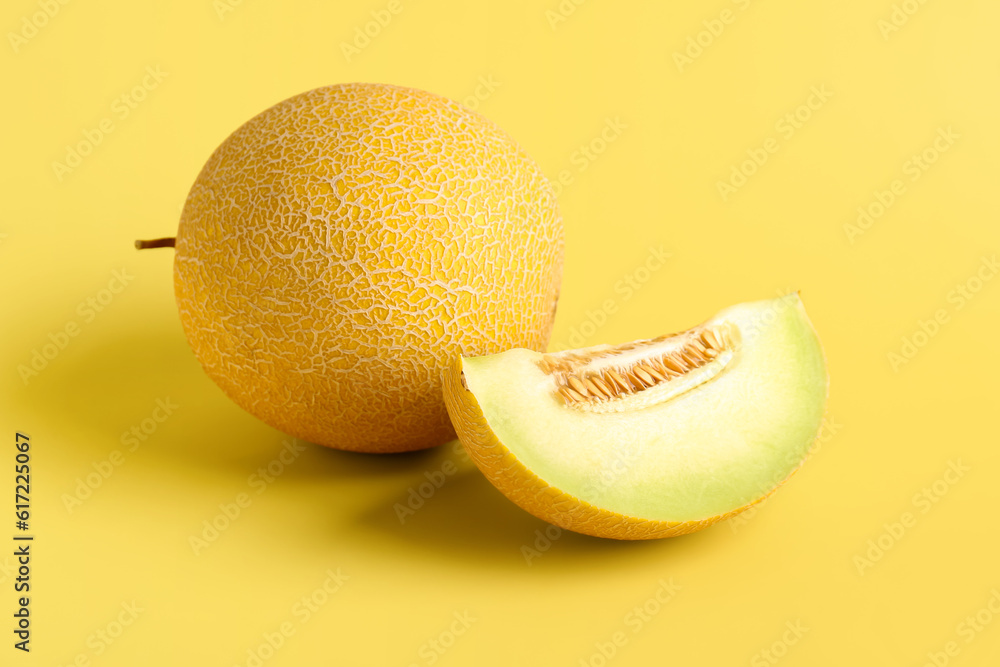 Sweet melon with piece on yellow background