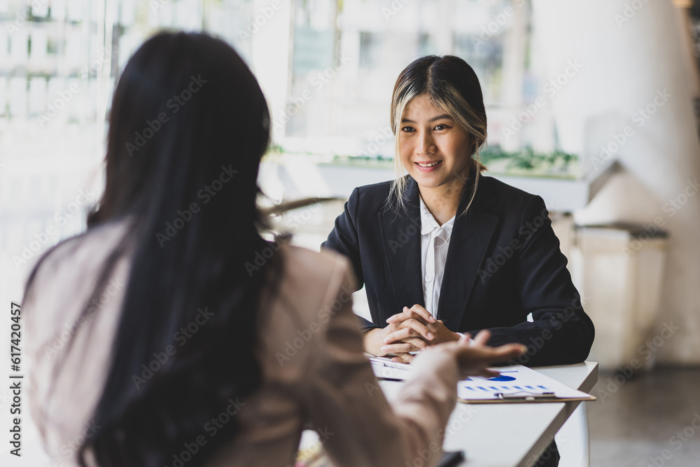 Businesswoman discussing with colleagues in the office, job interview.