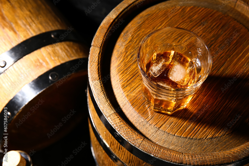 Barrel with glass of cold rum, closeup