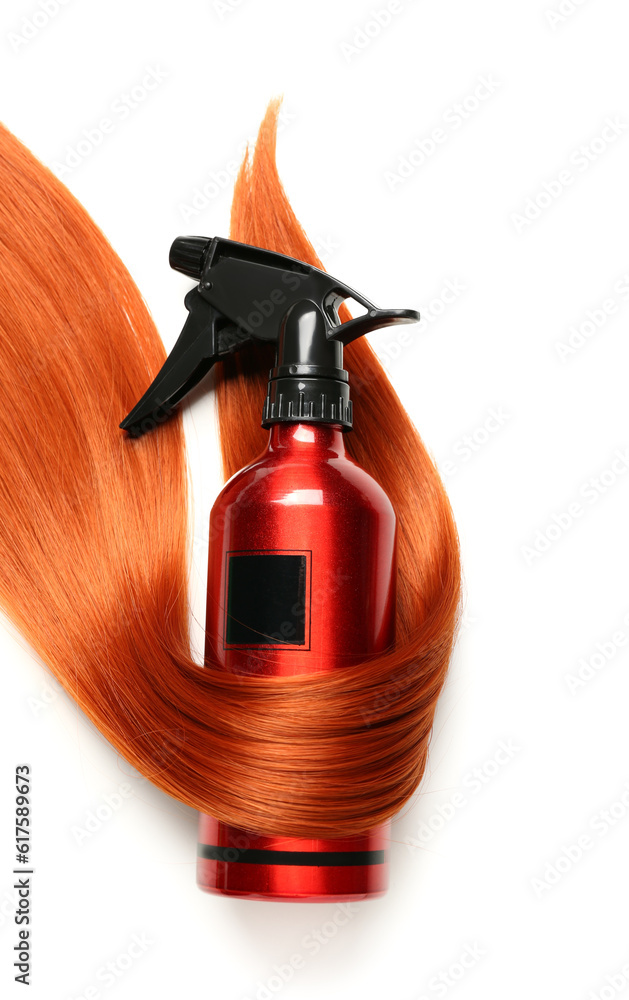 Ginger hair strand and sprayer on white background