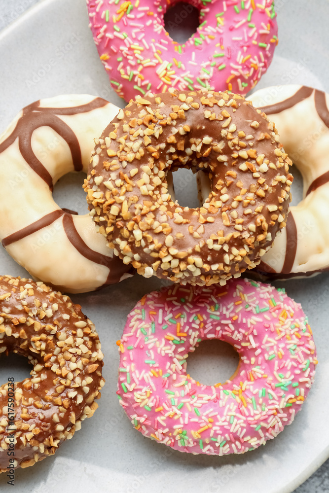 Plate with sweet donuts as background, closeup