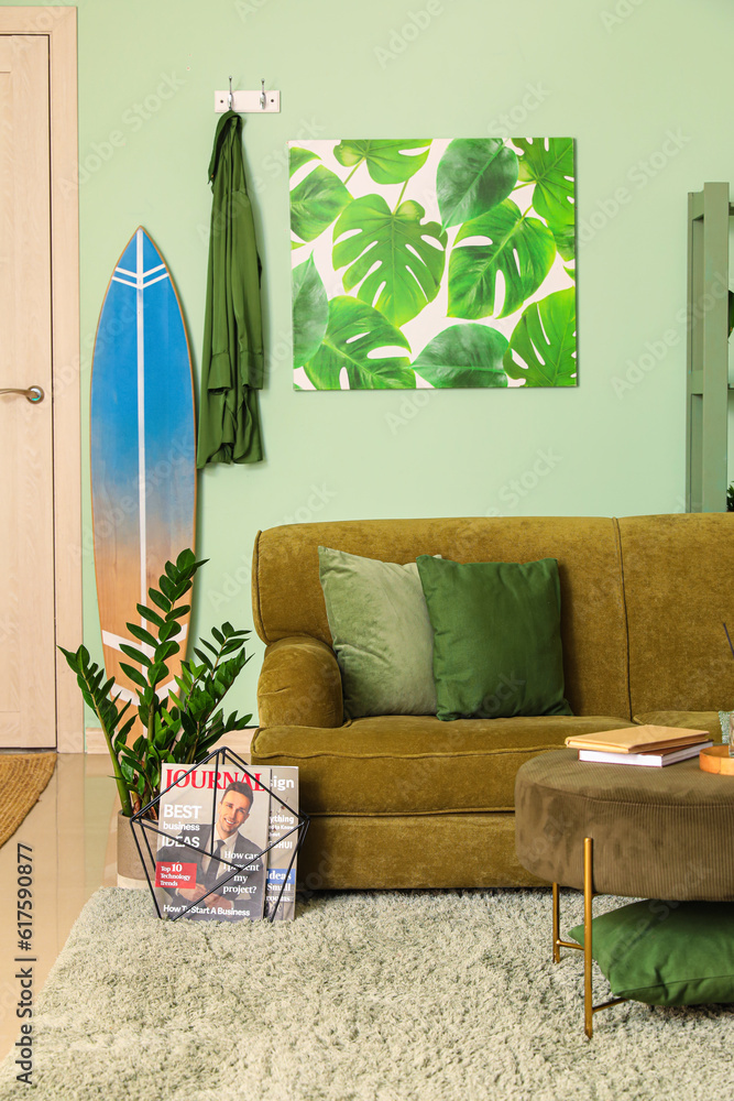 Interior of stylish living room with surfboard and sofa