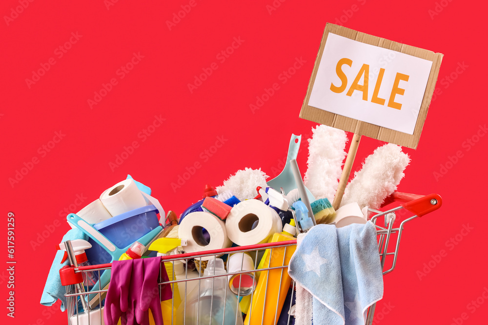 Shopping cart full of cleaning supplies with word SALE on red background