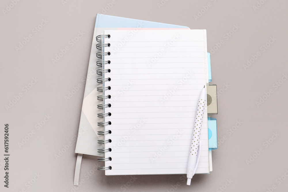 Notebooks with pen on grey background