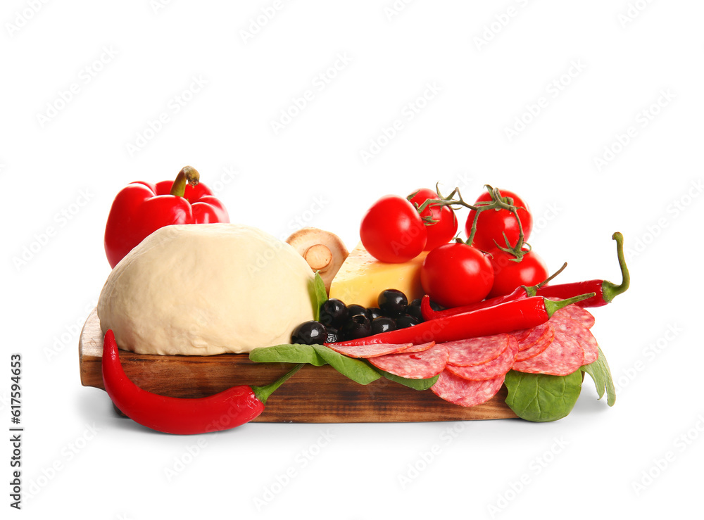 Wooden board with raw dough and ingredients for preparing pizza on white background