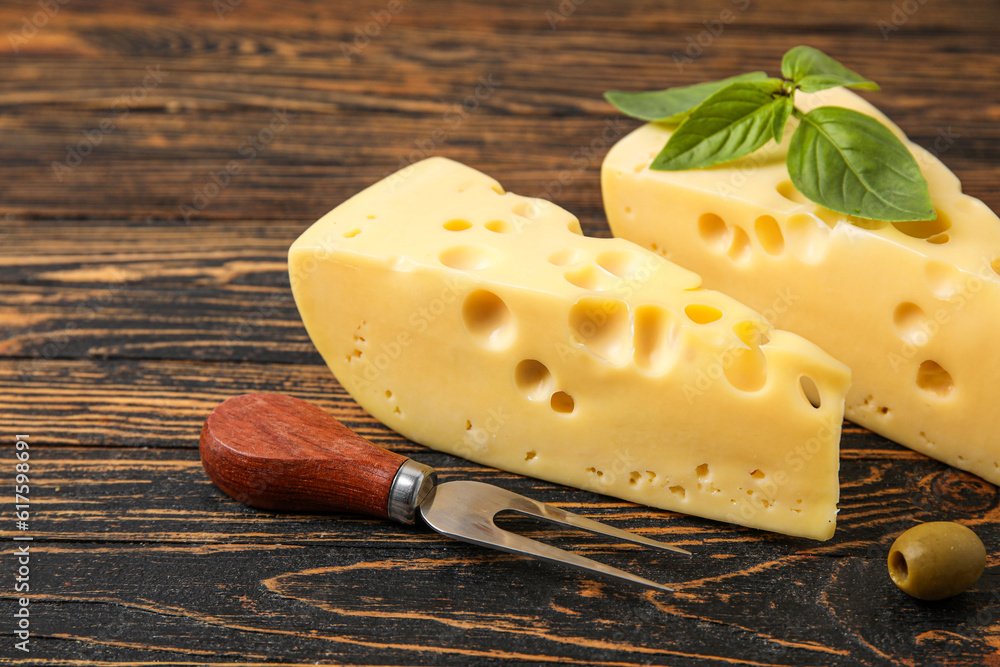 Tasty Swiss cheese on wooden background