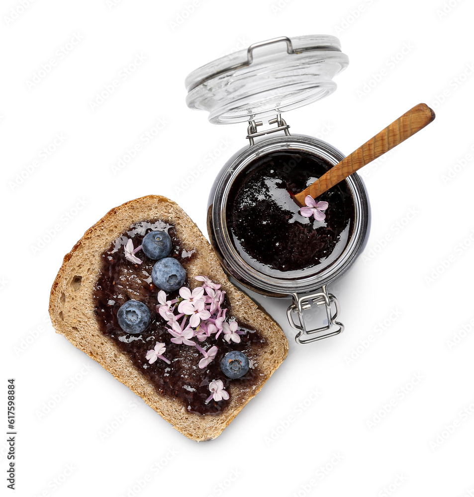 Jar and piece of bread with blueberry jam isolated on white background