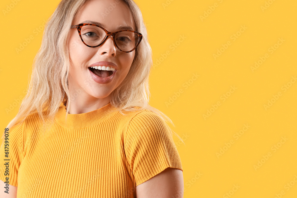 Young woman in stylish eyeglasses on orange background, closeup