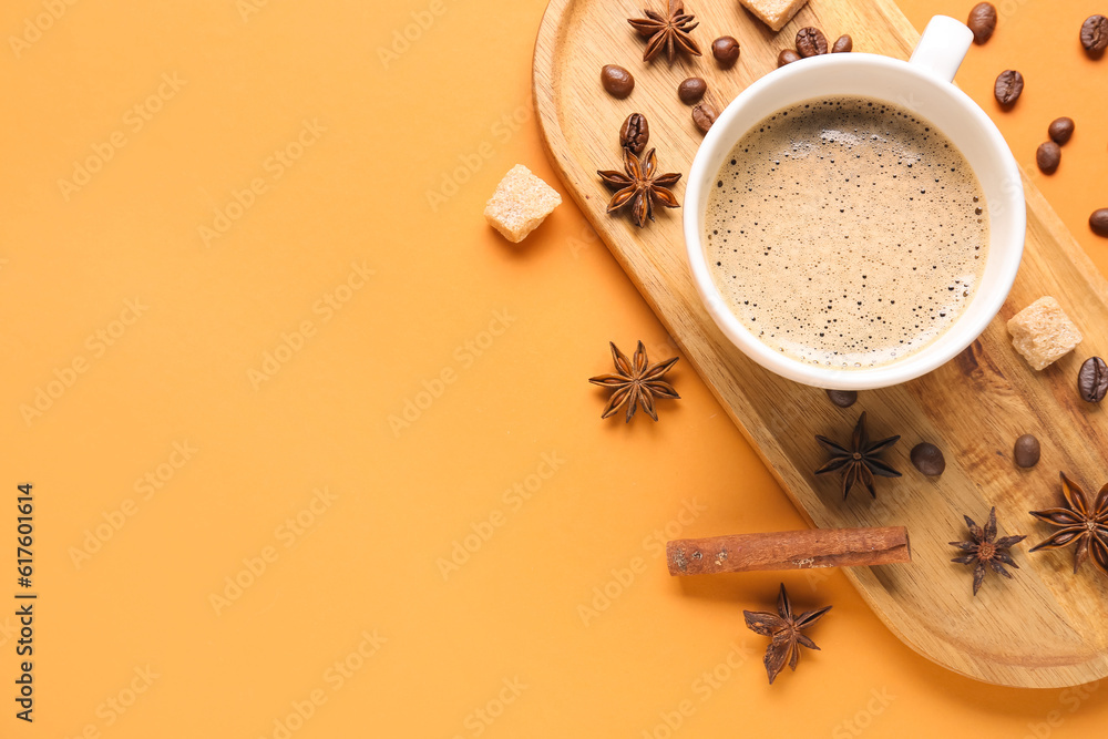 Board with cup of hot espresso and coffee beans on orange background