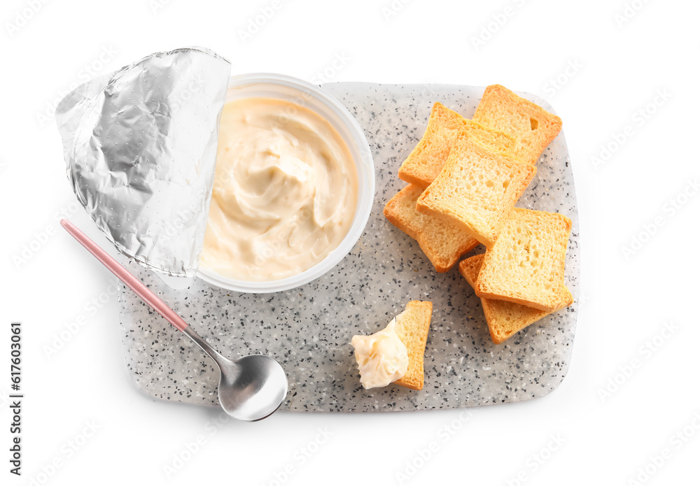 Plastic container with tasty cream cheese and croutons on white background