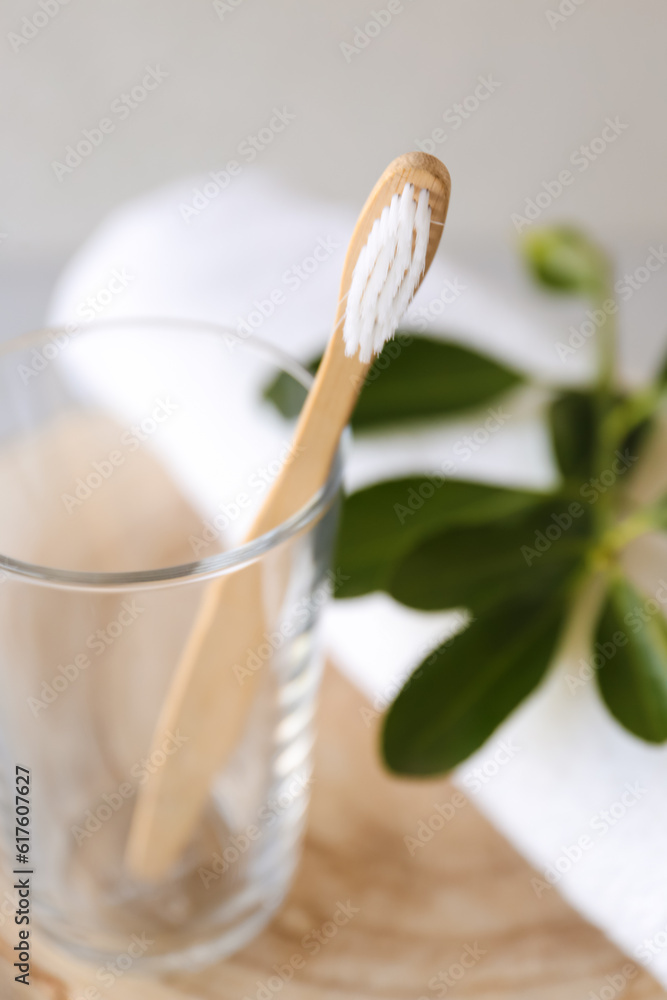 Bamboo tooth brush in holder on table, closeup