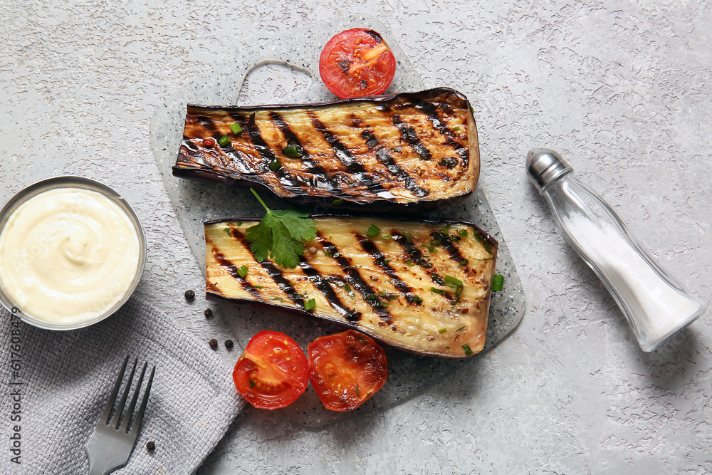 Delicious grilled eggplants, tomatoes and sauce on grey background