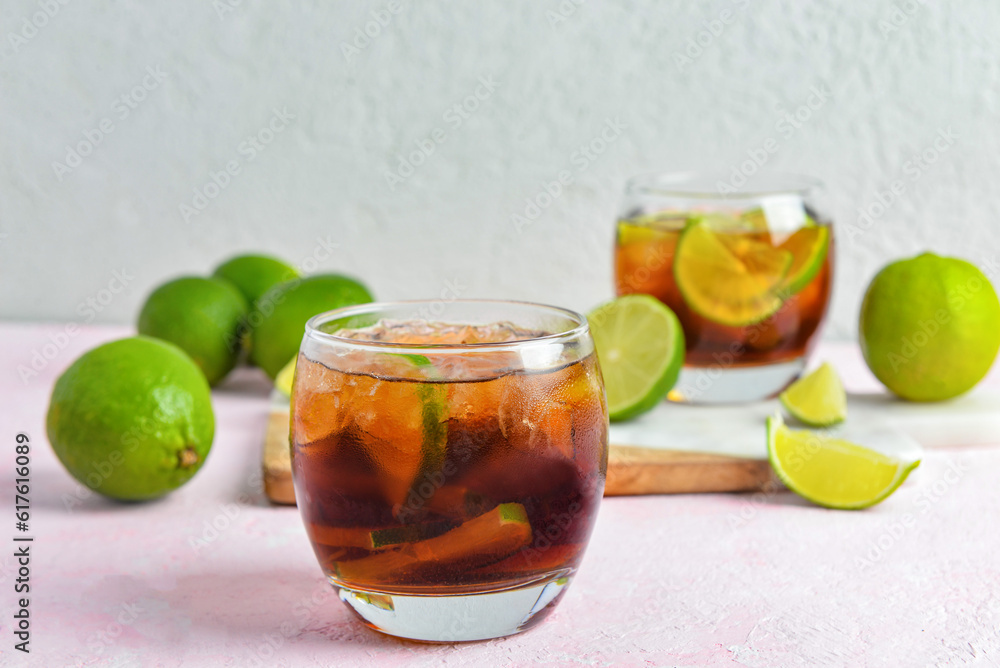 Glass of cold Cuba Libre cocktail on table