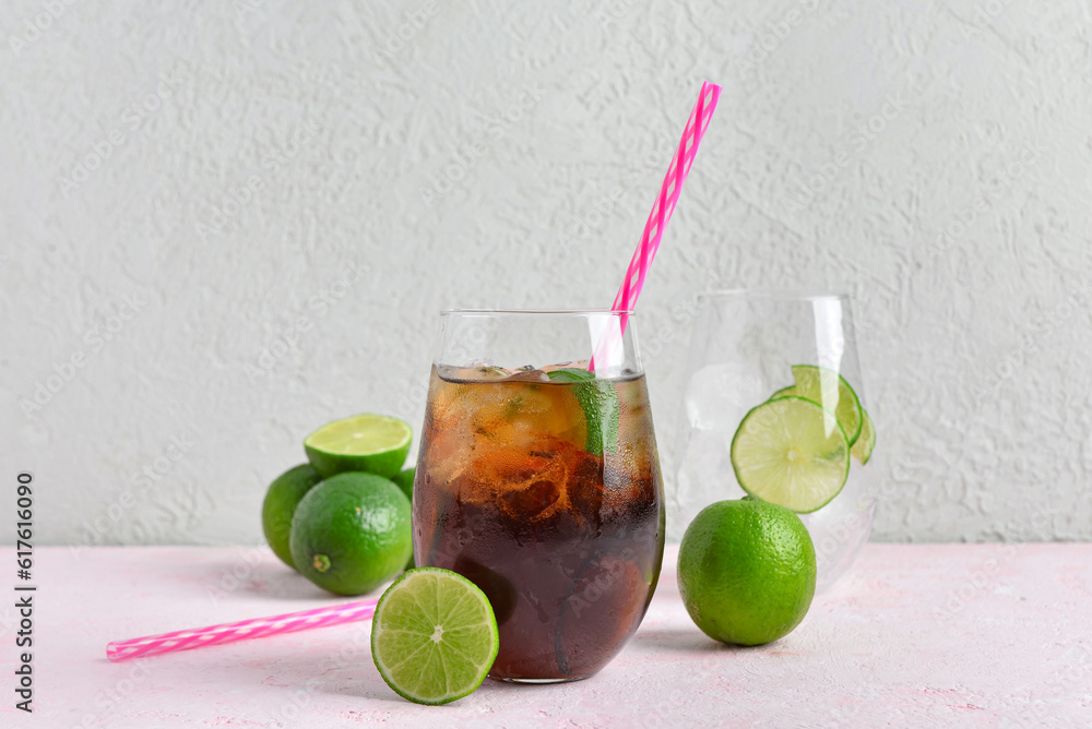 Glass of cold Cuba Libre cocktail on table