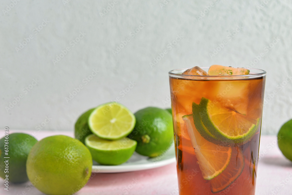 Glass of cold Cuba Libre cocktail on table