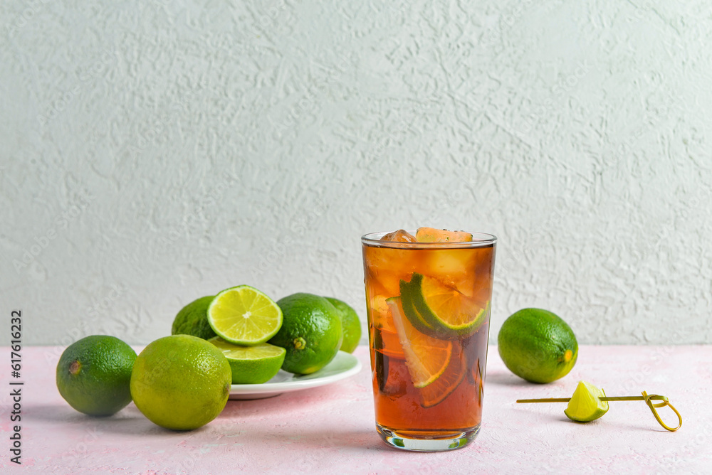 Glass of cold Cuba Libre cocktail on table