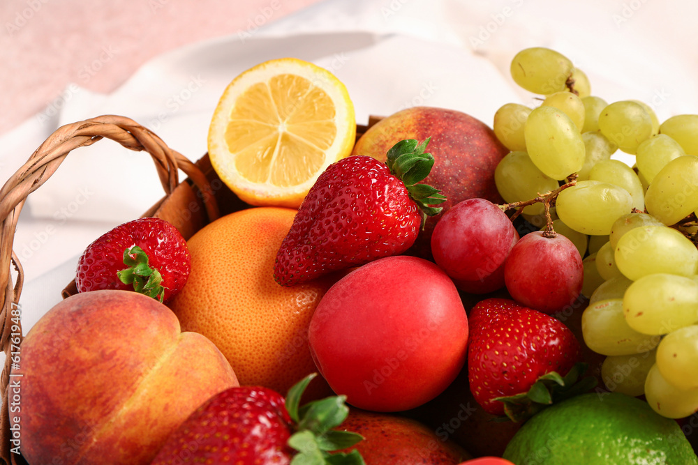 Wicker basket with different fresh fruits, closeup