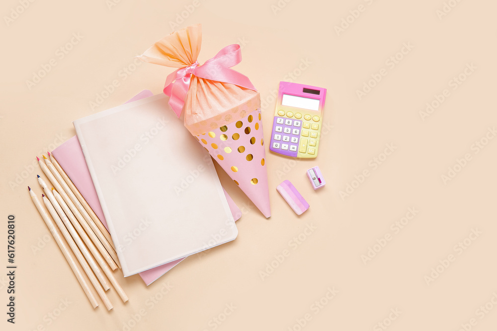 Pink school cone with different stationery on pale orange background