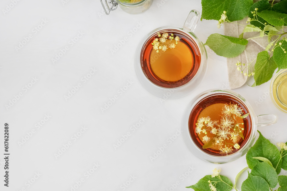 Glass cups of linden tea on white background