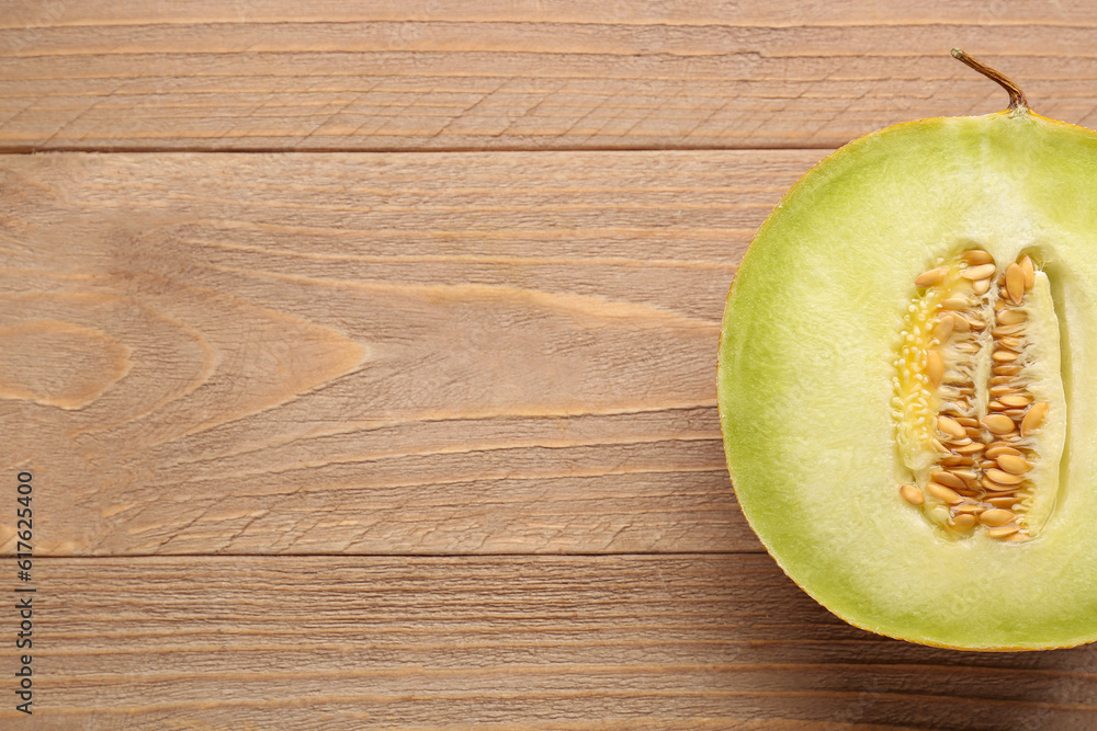 Half of sweet melon on wooden background