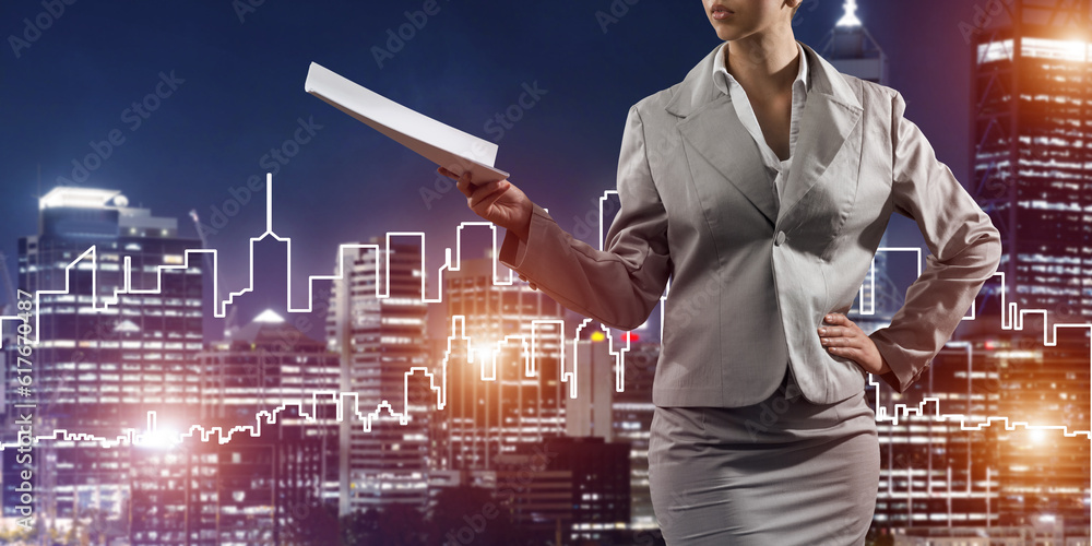 Woman architect or engineer presenting construction concept and holding documents in hand