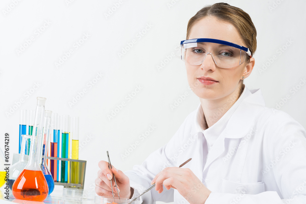 Microbiologist researching sample in petri dish.