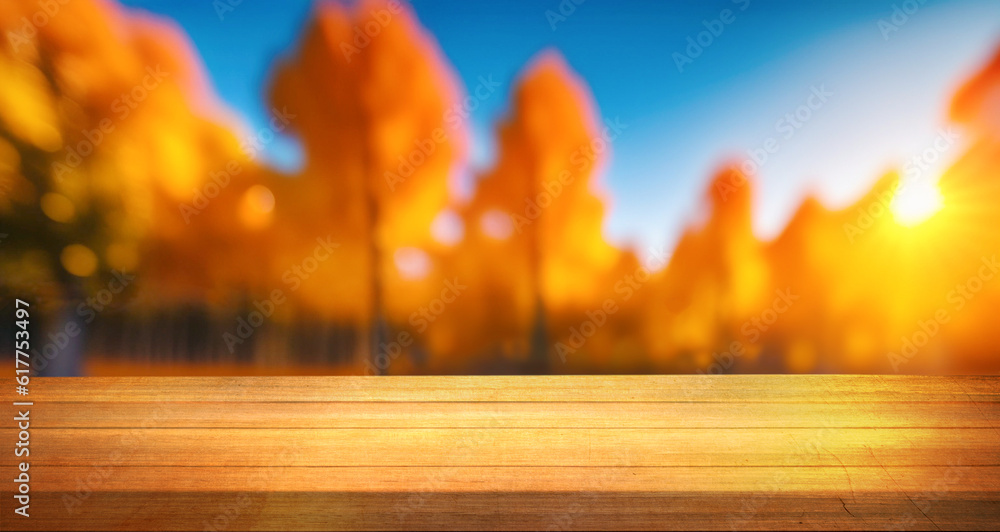 Wooden planks against the background blurred of trees in a beautiful autumn park. Autumn background 