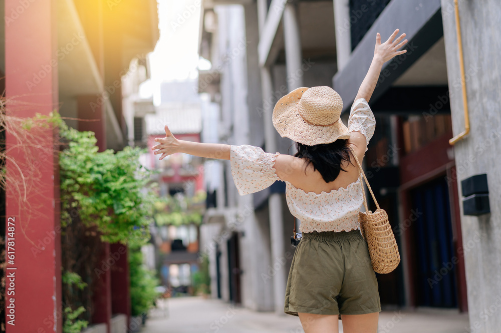 Happy youth asian woman with camera travels street city trip on leisure weekend. Young hipster femal