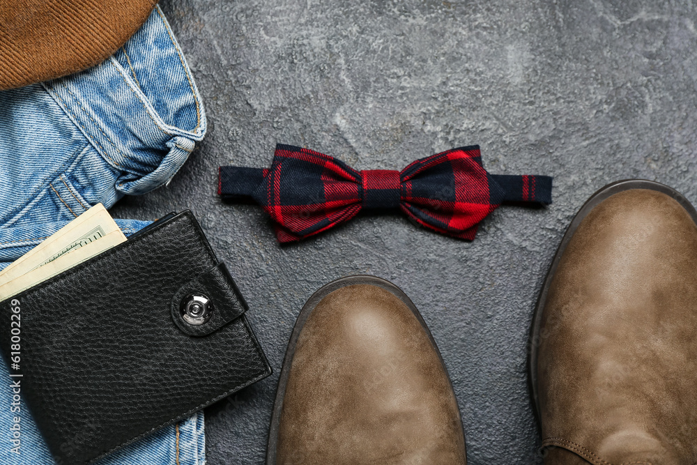 Composition with male shoes, clothes and accessories on dark background, closeup