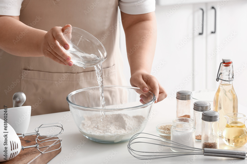 Woman preparing dough for Italian Grissini at table in kitchen, closeup